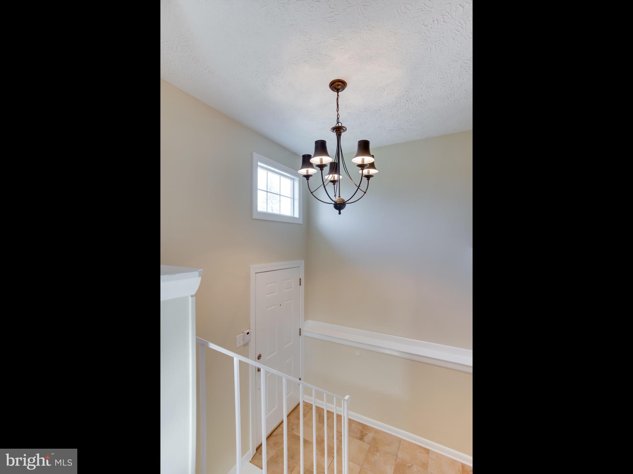 1925 Grant Road Baltimore, MD 21227 - Photo 3 of 44 a view of a hallway with a chandelier