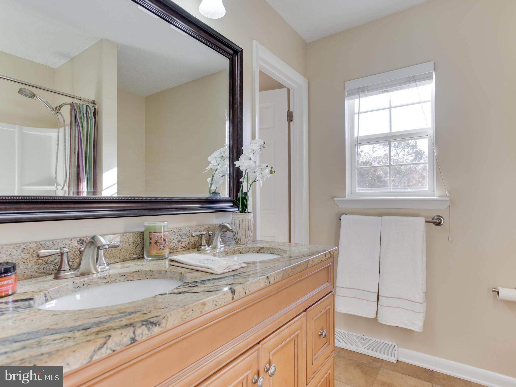 1925 Grant Road Baltimore, MD 21227 - Photo 24 of 44 a bathroom with a granite countertop sink and a mirror