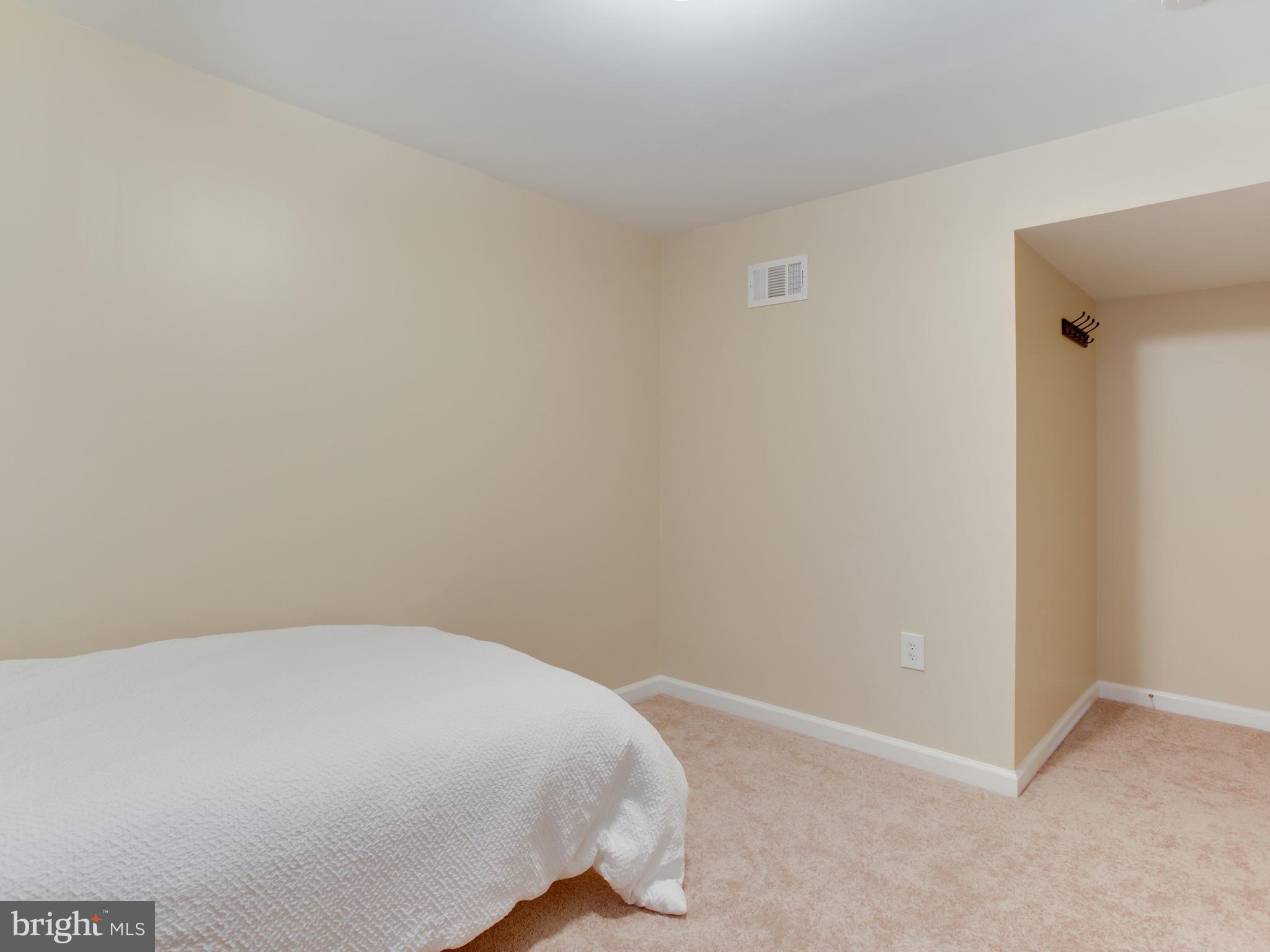 1925 Grant Road Baltimore, MD 21227 - Photo 37 of 44 a room with a bed and a wall painting