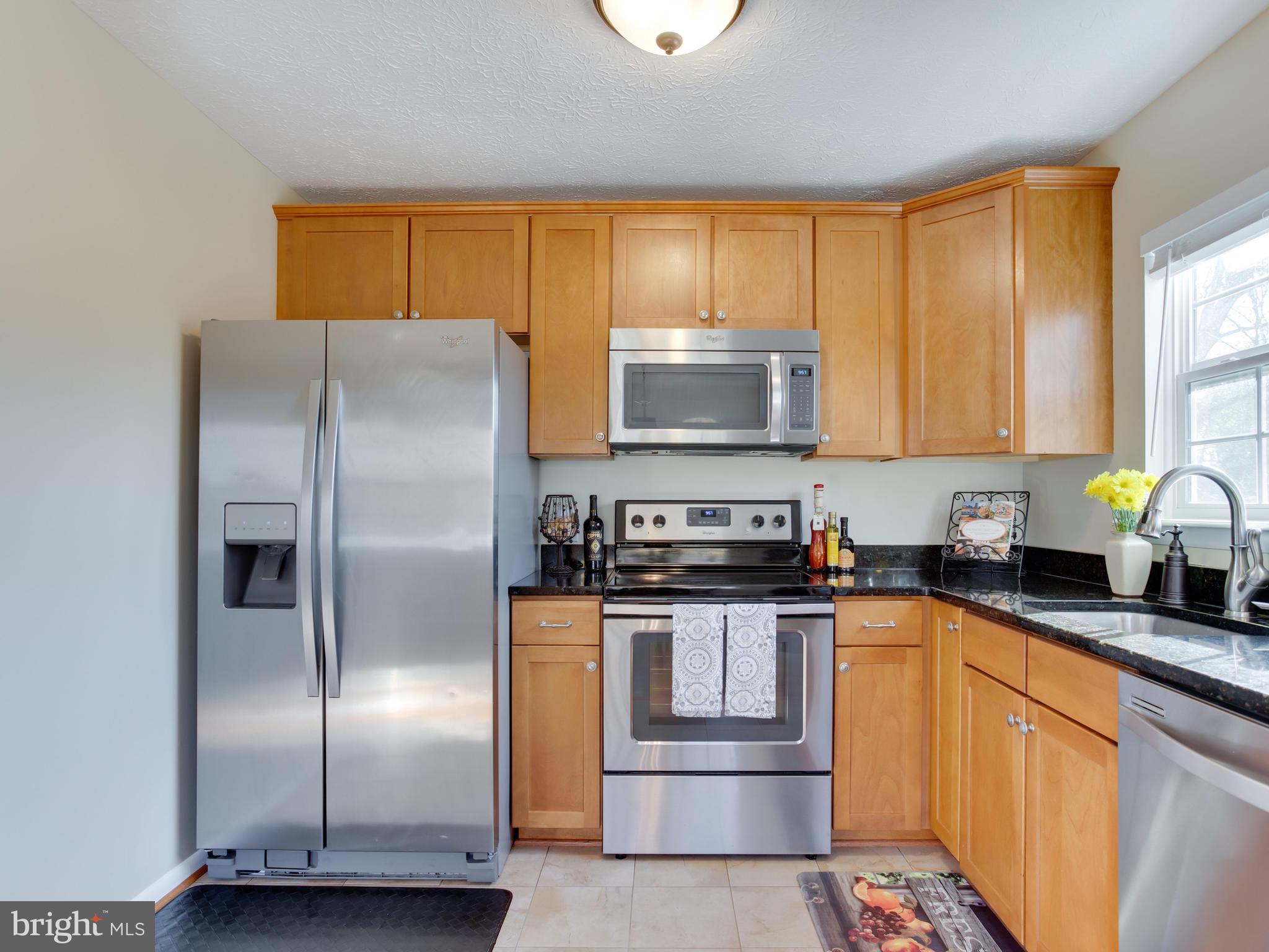 1925 Grant Road Baltimore, MD 21227 - Photo 7 of 44 a kitchen with stainless steel appliances granite countertop a refrigerator a stove a sink and a microwave