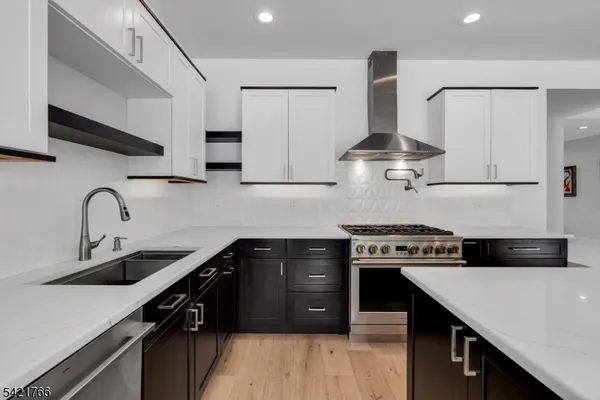 a kitchen with stainless steel appliances a sink stove and cabinets