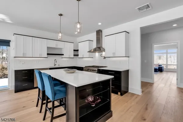 a kitchen with a stove a refrigerator and a fireplace