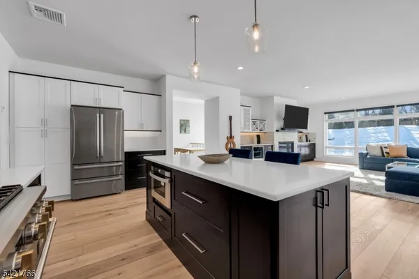 a kitchen with kitchen island a sink appliances and cabinets