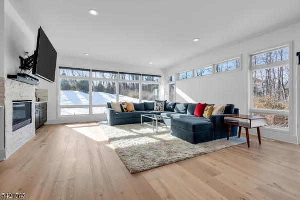 a living room with furniture flat screen tv and a fireplace