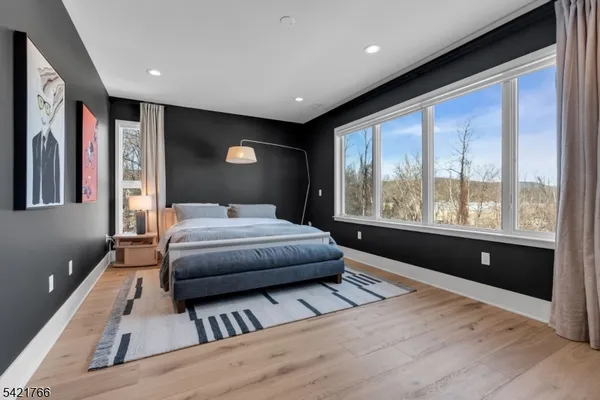 a bedroom with a large bed and a large window