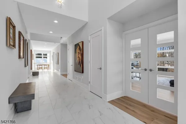 a view of a hallway with wooden floor and windows