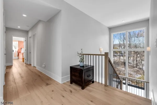 a room with wooden floor and a floor to ceiling window