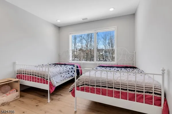 a bedroom with two beds and window