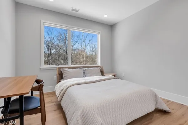 a large bed sitting in a bedroom next to a window