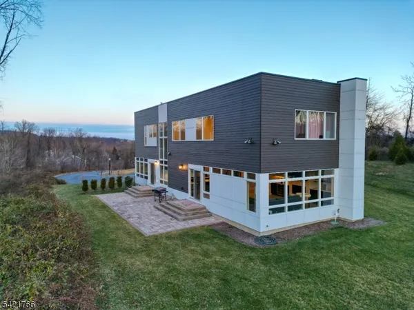 a view of a house with backyard porch and sitting area