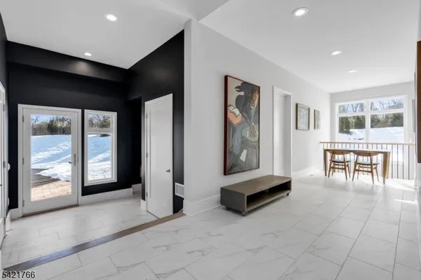 a living room with furniture and large windows