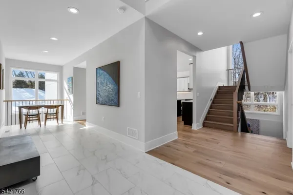 a view of a livingroom with wooden floor and stairs