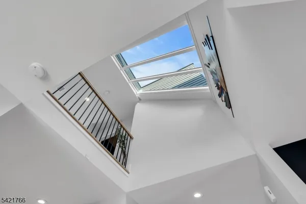 a view of staircase with white walls and railing
