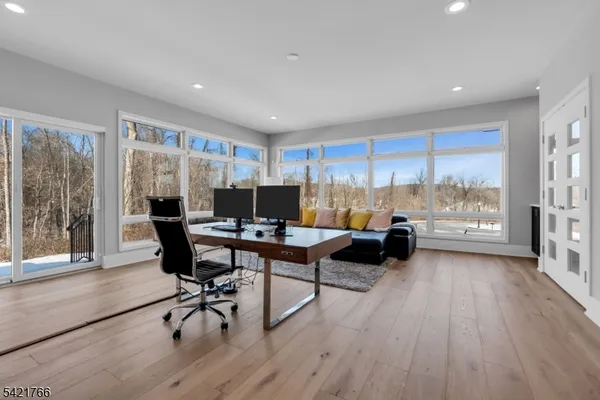 a workspace with furniture window and wooden floor