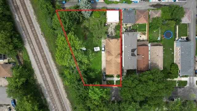 an aerial view of a house with a yard and outdoor seating