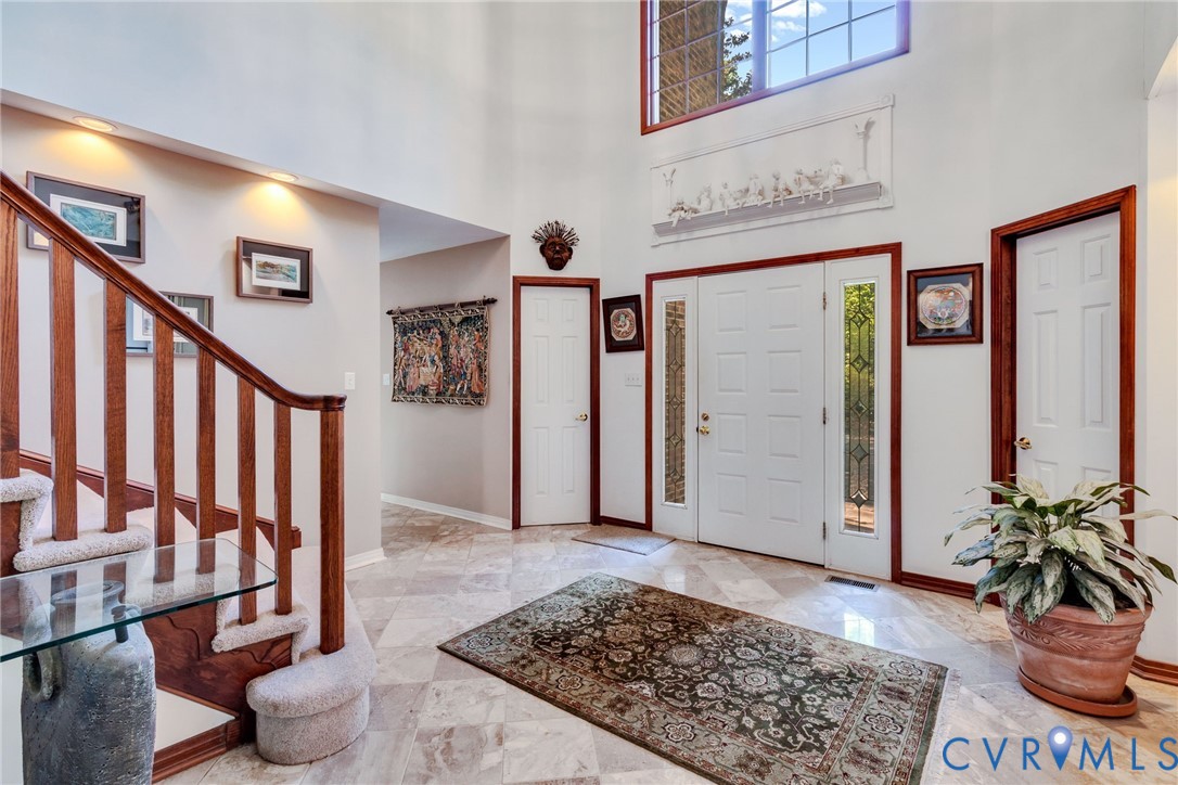 1167 Ottoman Ferry Road Lancaster, VA 22503 - Photo 11 of 52 Two-story entryway featuring a white paneled door