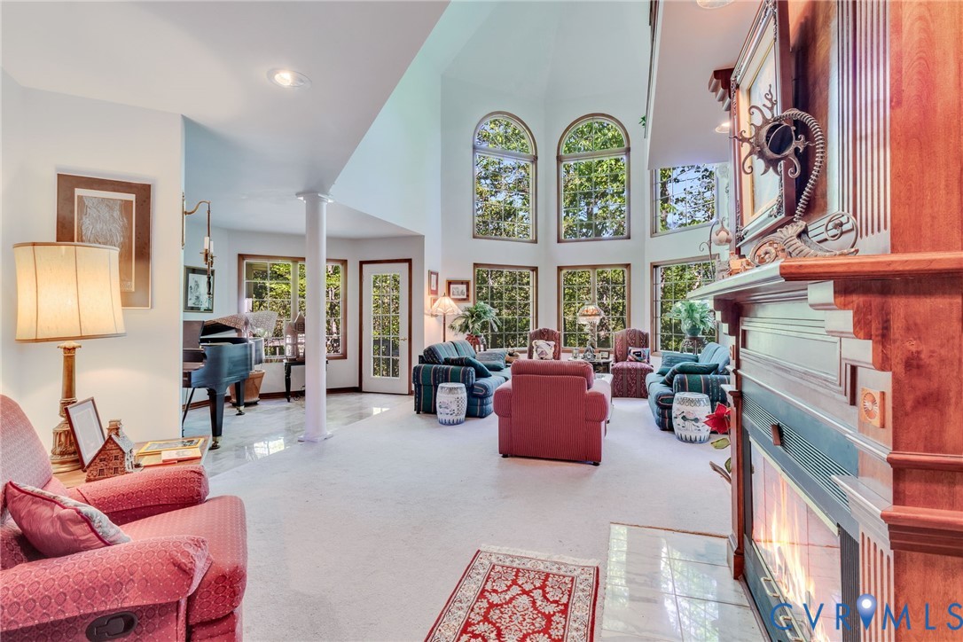 1167 Ottoman Ferry Road Lancaster, VA 22503 - Photo 15 of 52 Grand living space featuring a two-story ceiling a