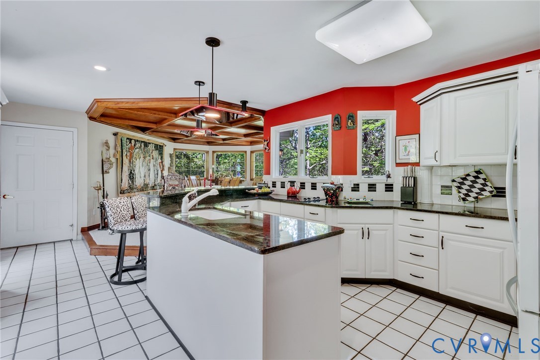 1167 Ottoman Ferry Road Lancaster, VA 22503 - Photo 16 of 52 Kitchen with white cabinetry, black countertops, a