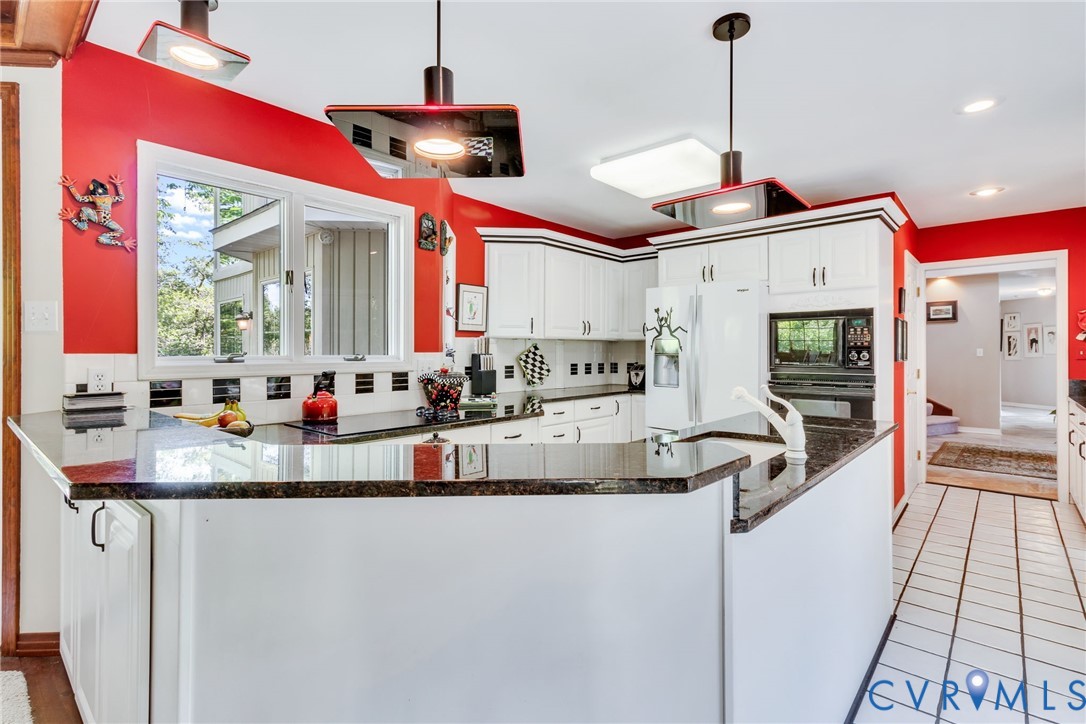 1167 Ottoman Ferry Road Lancaster, VA 22503 - Photo 17 of 52 Kitchen featuring white cabinetry, dark granite-st