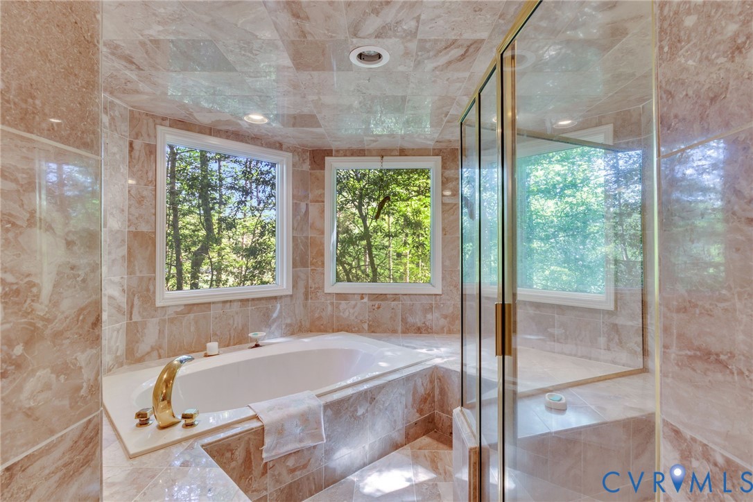 1167 Ottoman Ferry Road Lancaster, VA 22503 - Photo 23 of 52 Recessed soaking tub with gold-finish fixtures and