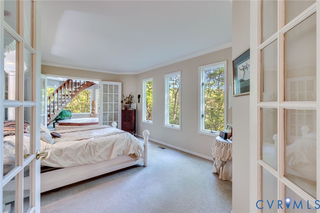 1167 Ottoman Ferry Road Lancaster, VA 22503 - Photo 25 of 52 Bedroom featuring light-toned carpeting, crown mol