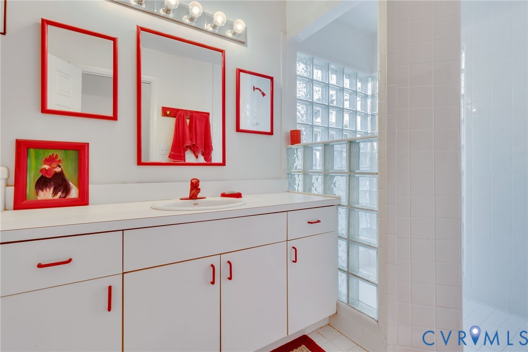 1167 Ottoman Ferry Road Lancaster, VA 22503 - Photo 29 of 52 Vanity with integrated sink, white countertop, and
