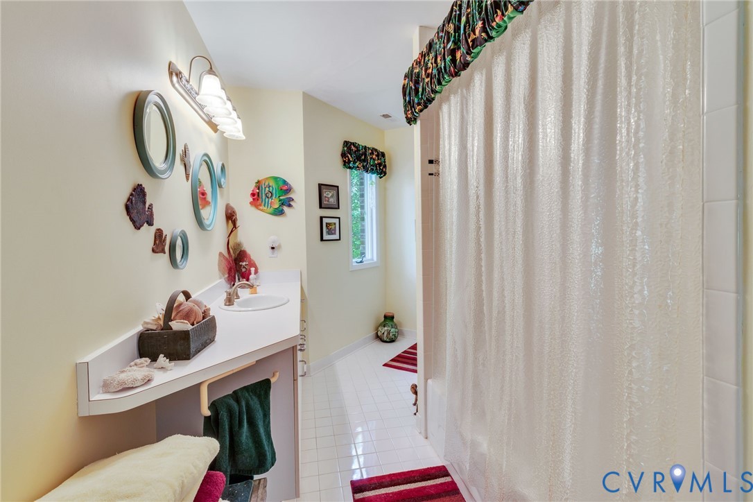 1167 Ottoman Ferry Road Lancaster, VA 22503 - Photo 39 of 52 Bathroom featuring a single vanity with an undermo