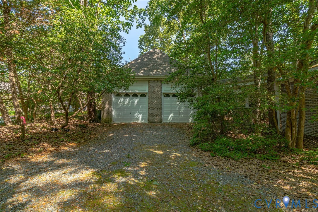 1167 Ottoman Ferry Road Lancaster, VA 22503 - Photo 40 of 52 Two-car garage with white paneled doors featuring