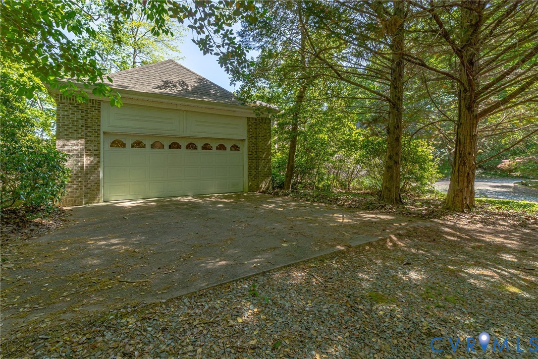 1167 Ottoman Ferry Road Lancaster, VA 22503 - Photo 42 of 52 Attached garage featuring a light-colored sectiona