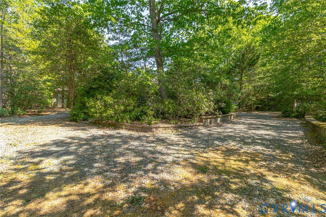 1167 Ottoman Ferry Road Lancaster, VA 22503 - Photo 46 of 52 Gravel driveway surrounded by mature trees and lus
