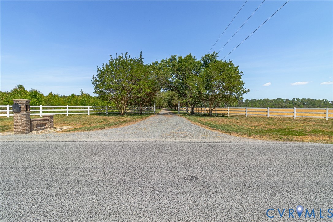 1167 Ottoman Ferry Road Lancaster, VA 22503 - Photo 52 of 52 Gravel drive entrance framed by mature trees, a wh