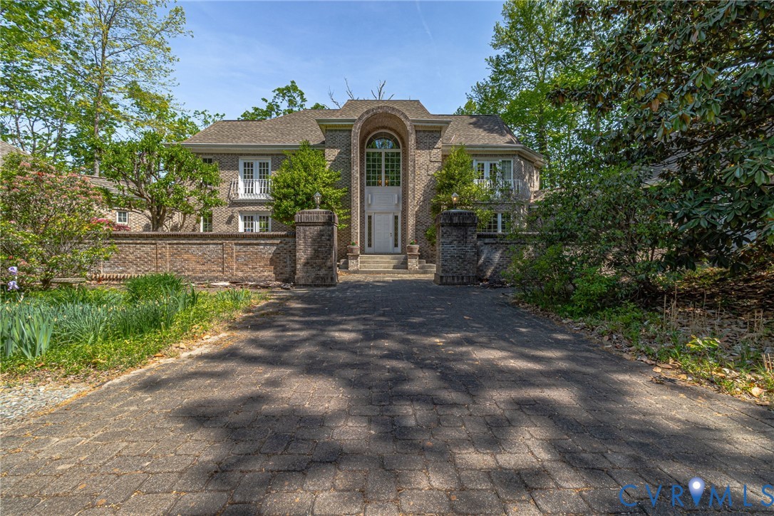 1167 Ottoman Ferry Road Lancaster, VA 22503 - Photo 6 of 52 Brick paver driveway leading to a stone facade res