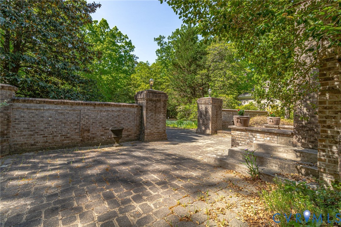 1167 Ottoman Ferry Road Lancaster, VA 22503 - Photo 7 of 52 Cobblestone paving leads to a brick wall entrance