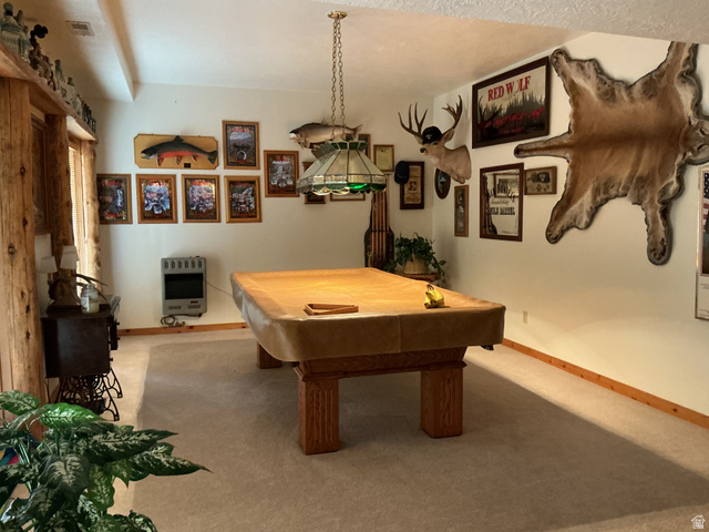 550 State Line Road Manila, UT 84046 - Photo 19 of 41 Recreation room featuring a central billiard table with a Tiffany-style pendant light, light-toned carpeting, and natural wood trim