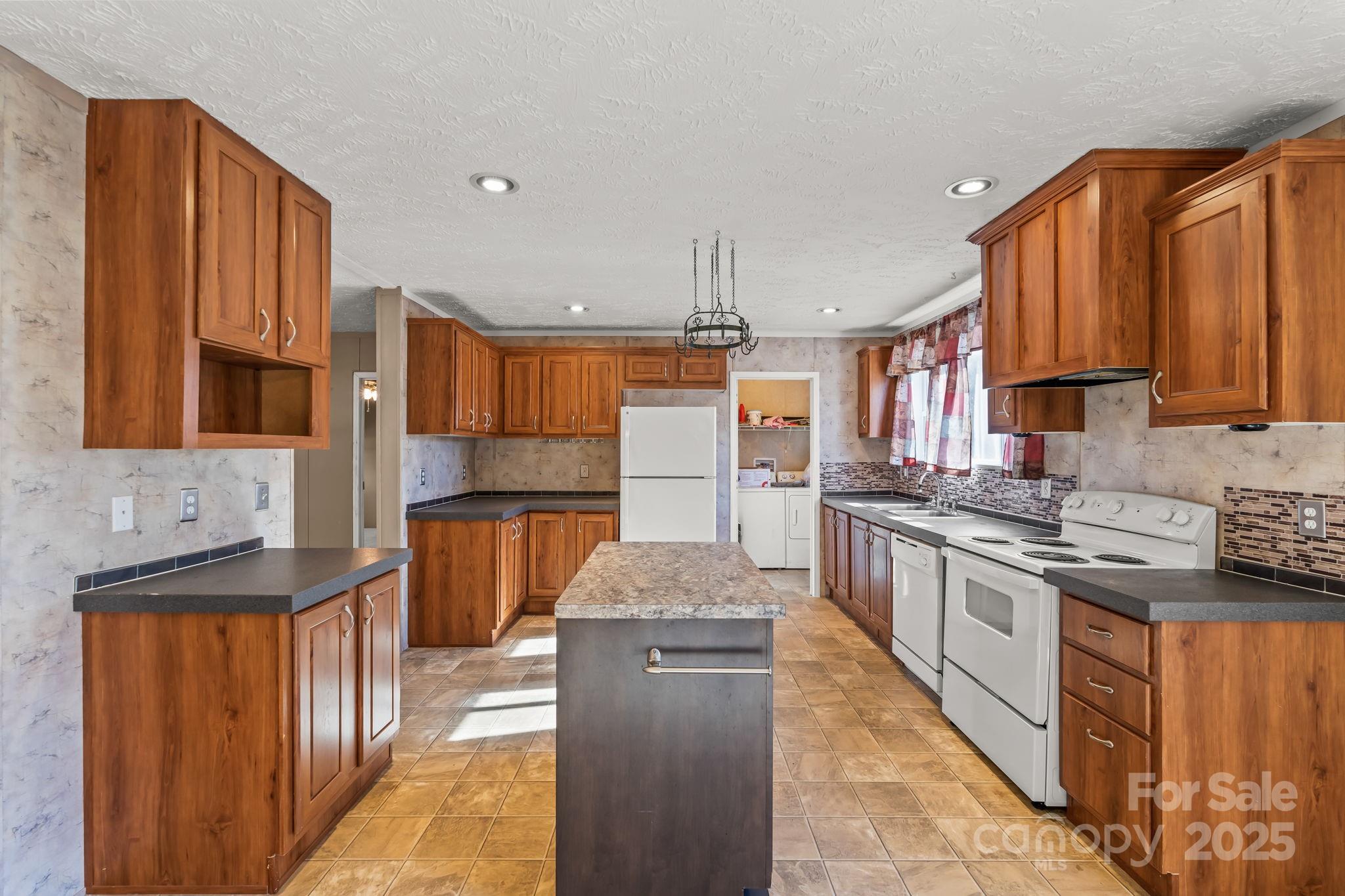 1060 Beckham Road Salisbury, NC 28147 - Photo 11 of 28 a kitchen with stainless steel appliances granite countertop a stove a sink and a refrigerator