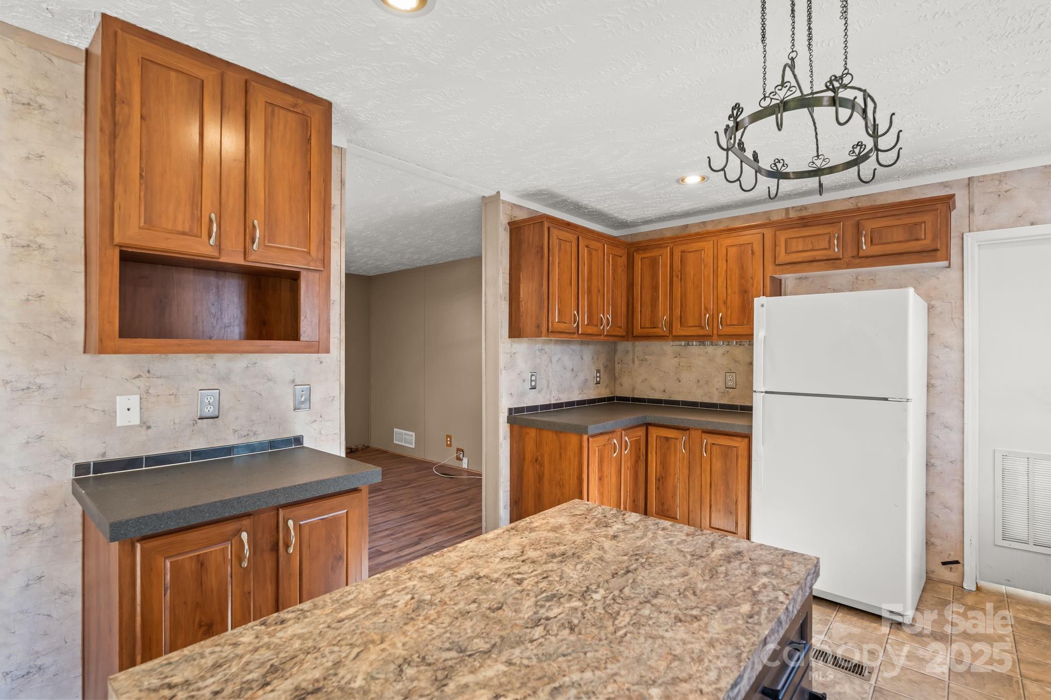 1060 Beckham Road Salisbury, NC 28147 - Photo 15 of 28 a kitchen with stainless steel appliances granite countertop a sink refrigerator stove and microwave