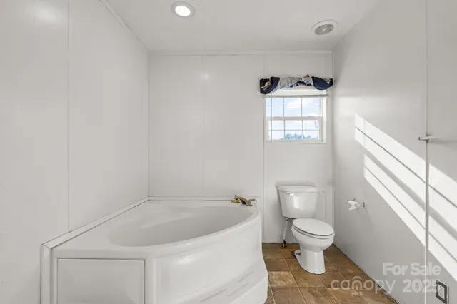 a white toilet sitting next to a white sink