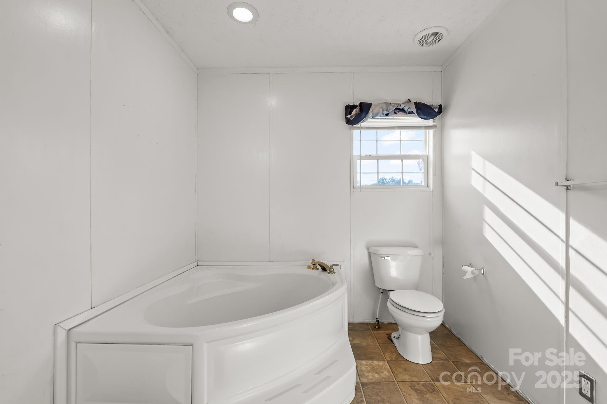 1060 Beckham Road Salisbury, NC 28147 - Photo 20 of 28 a white toilet sitting next to a white sink