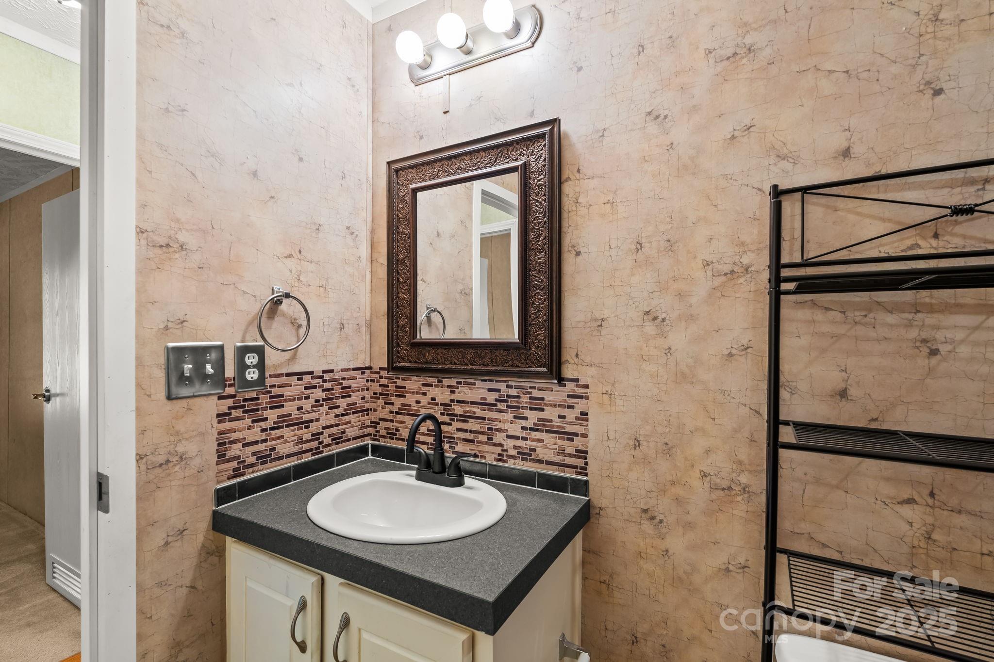 1060 Beckham Road Salisbury, NC 28147 - Photo 28 of 28 a bathroom with a sink and a mirror