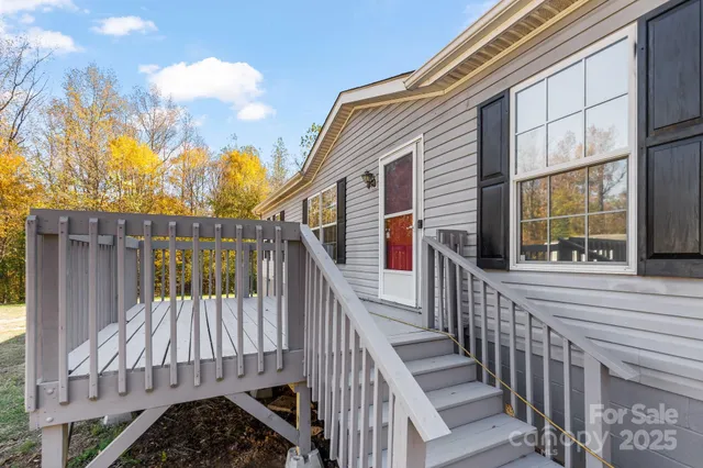 a view of balcony with wooden floor and fence