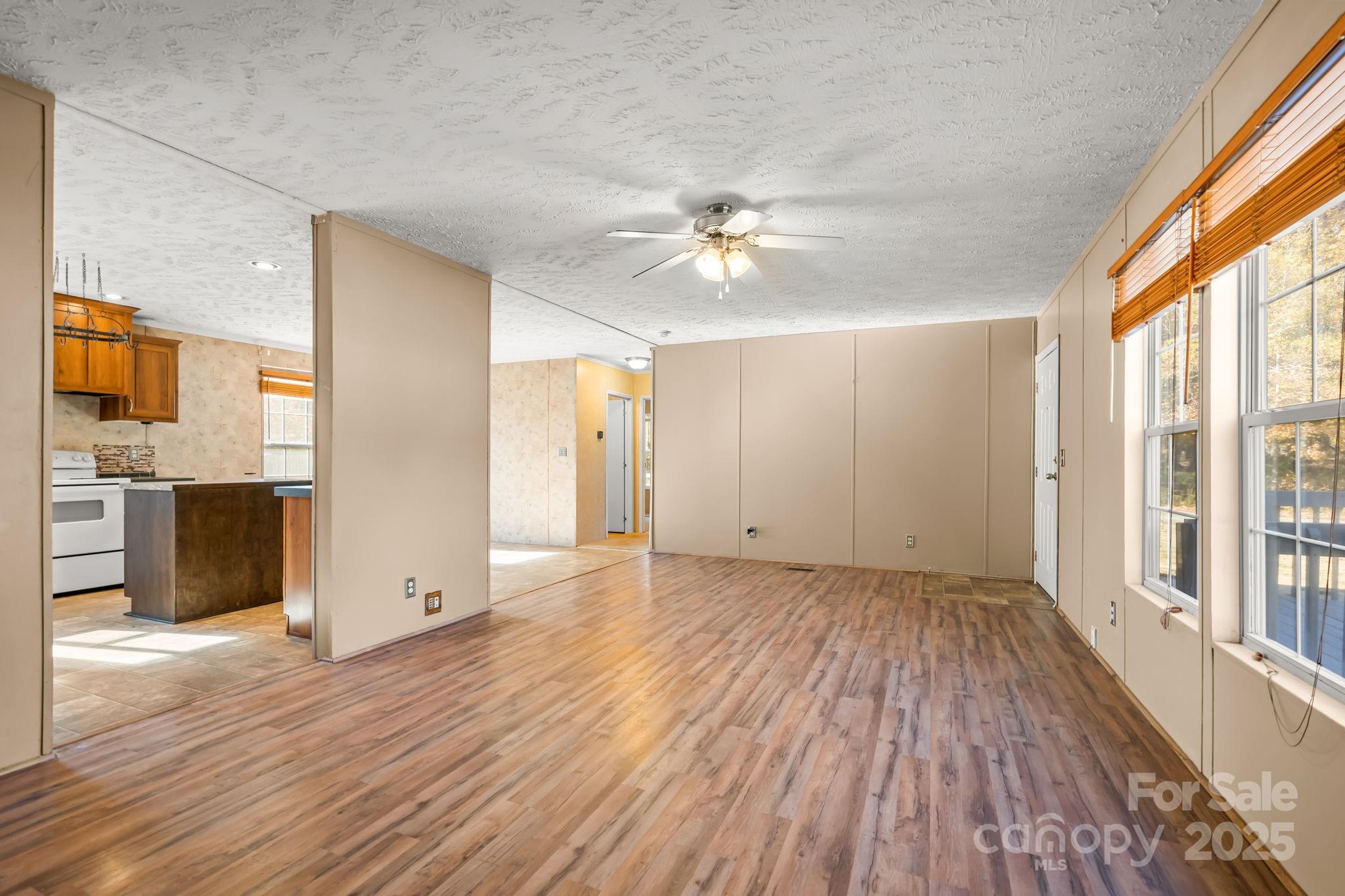 1060 Beckham Road Salisbury, NC 28147 - Photo 10 of 28 a view of empty room with wooden floor and fan