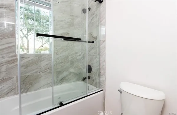 a bathroom with a shower and toilet