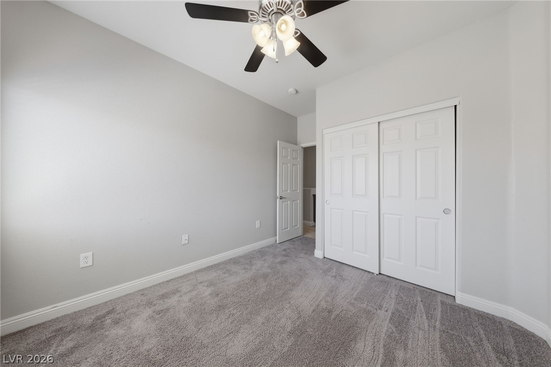 6312 Sandy Ridge Street, Unit 3102 North Las Vegas, NV 89081 - Photo 20 of 31 A well-proportioned bedroom with ample space, carpeted flooring, and a large sliding closet.
