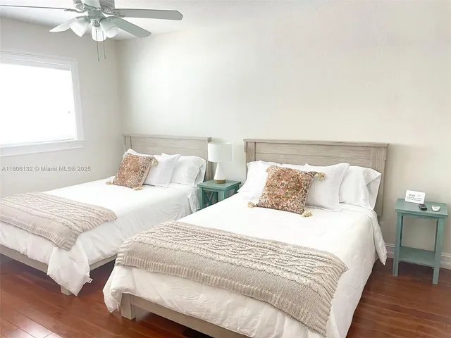 a bedroom with two beds and a chandelier