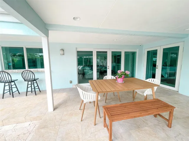 a swimming pool with outdoor seating and yard