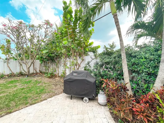 a backyard of a house with lots of green space and fountain