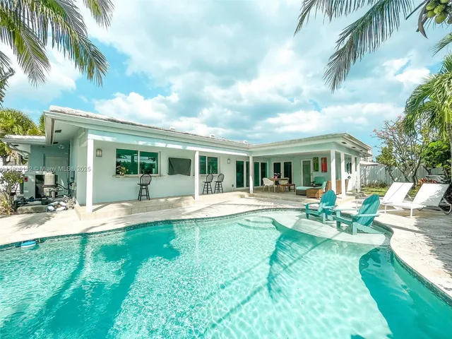 a view of house with a backyard and a patio
