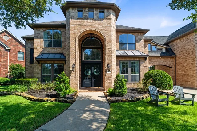 a front view of a house with garden