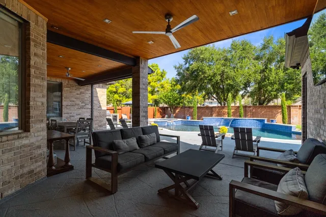 a view of a patio with table and chairs and potted plants