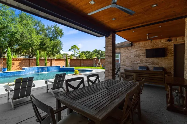 a backyard of a house with fire pit and outdoor seating